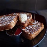 French Toast · Fresh thick-sliced brioche bread, custard-dipped and topped with powdered cinnamon sugar.