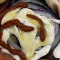 Lamb Gyro · Lamb Gyro served with Pita, lettuce, tomatoes, white sauce and hot sauce.