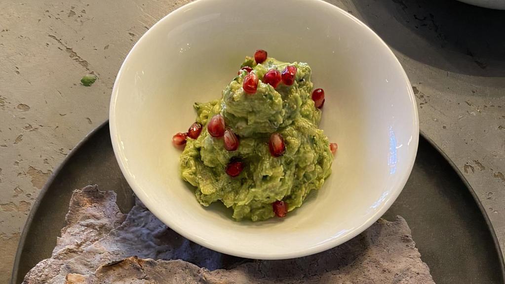 Guacamole · Fresh avocado smashed with lime juice, cilantro-onions and jalapenos. Served with crispy Tlayuda chips and homemade chipotle salsa. Garnished with pomegranate seeds.