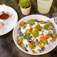 Nachos · Crispy corn chips covered with black beans, pickled jalapeno and melted Oaxaca cheese. Garni...