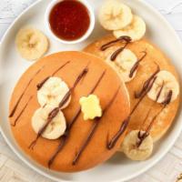 Wanna Banana Pancakes · Fluffy banana pancakes cooked with care and love served with butter and maple syrup. Served ...
