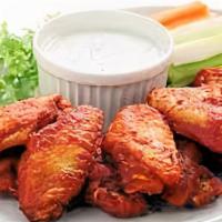 Buffalo Wings · 10 buffalo wings prepared in hot sauce and served on a bed of lettuce with carrot and celery...