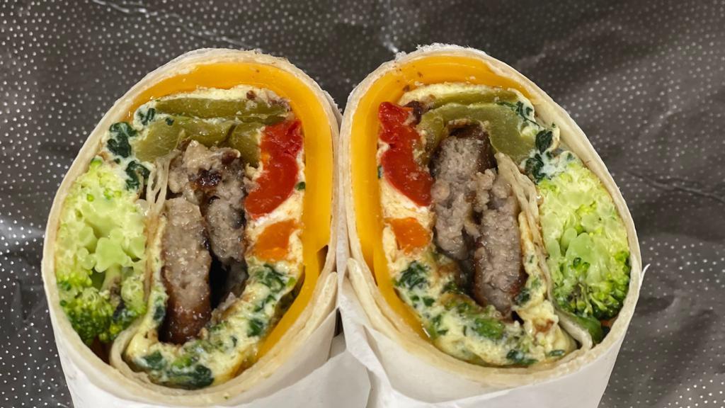 Morning Country Wrap · Our delicious wrap with eggs , spinach, green peppers, cheddar cheese,  sausage, lettuce
,tomato , mayo and  ketchup