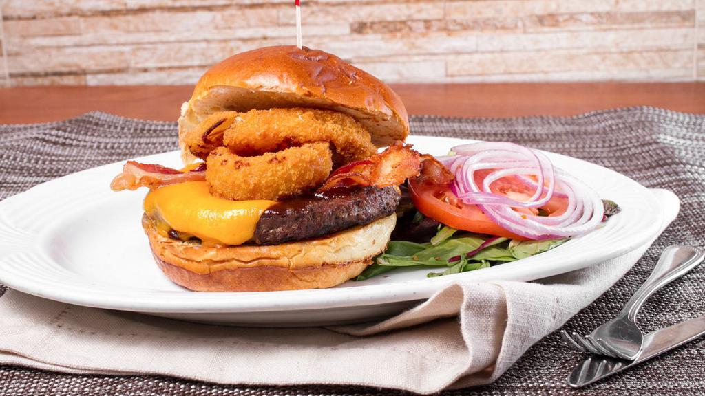 Barbecue Burger · Our delicious smoked bbq sauce, bacon, Cheddar cheese and onion rings. Served on a brioche bun and coleslaw and pickle upon request