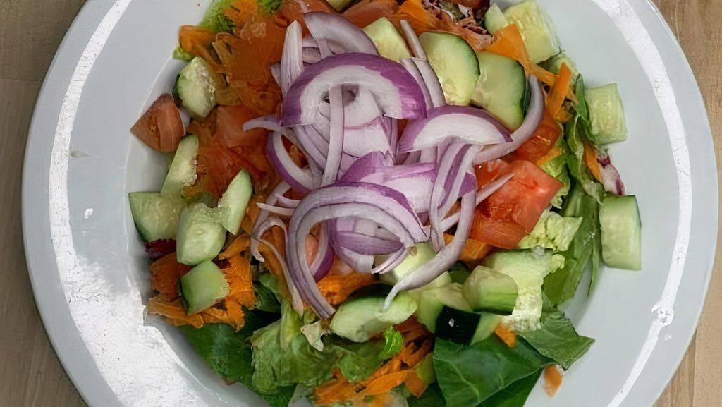 House Salad · Mixed greens, carrots, onions, cucumbers & tomatoes; served with a side of your choice of dressing