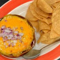 Thatcher'S Chili · Topped with melted cheddar & chopped red onions; served with tortilla chips