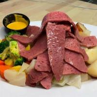 Corned Beef & Cabbage · Drizzled with butter & served with cabbage, red potatoes & seasonal vegetables
