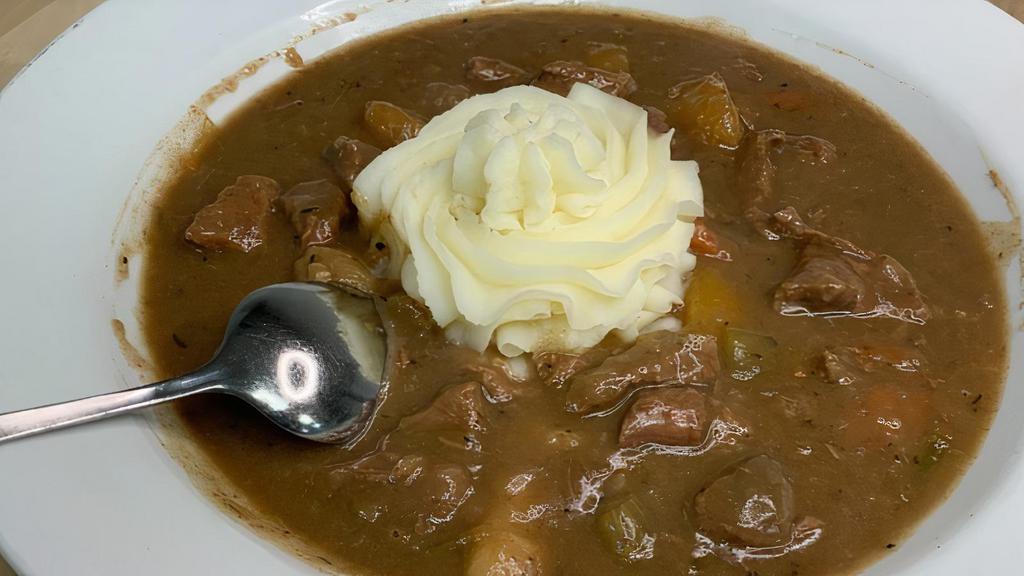 Guinness Beef Stew · Topped with mashed potatoes & served with a buttered Irish Scone