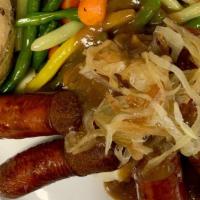 Bangers & Mash · Irish pork sausages & mashed potatoes; topped with brown gravy & sautéed onions; served with...
