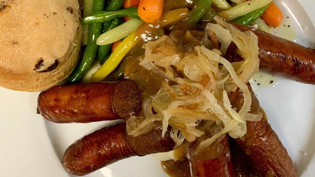 Bangers & Mash · Irish pork sausages & mashed potatoes; topped with brown gravy & sautéed onions; served with seasonal vegetables & a buttered Irish scone