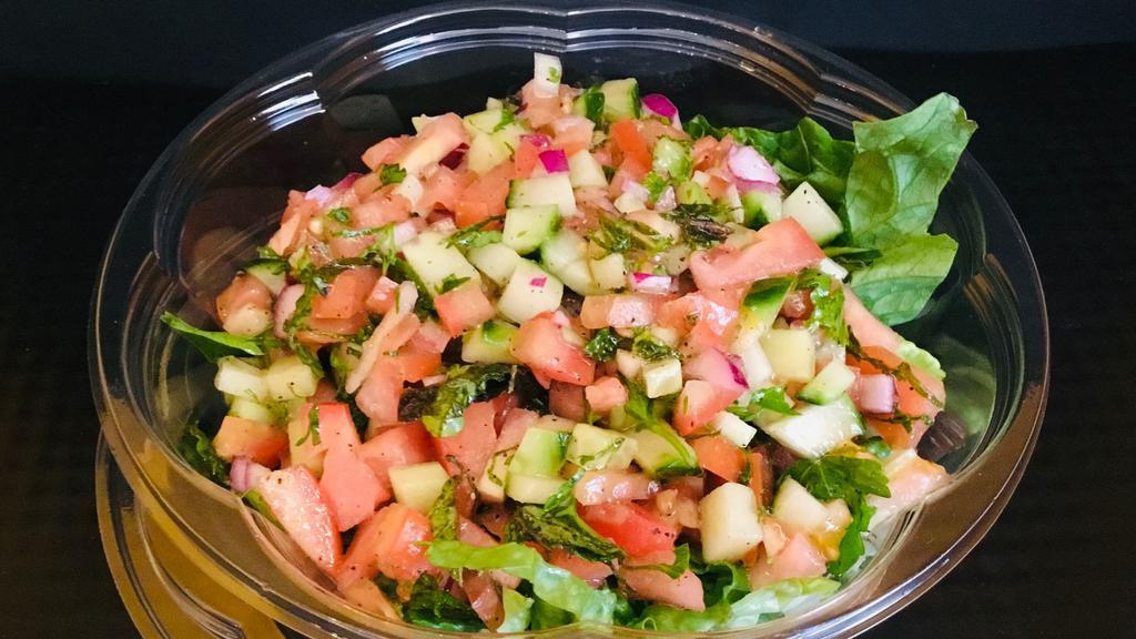 Israeli Salad · Mixed greens, chopped tomato, chopped cucumber, red onion, chopped mint leaf, fresh lemon juice olive oil, salt and pepper. Served with balsamic dressing on the side and dressed with olive oil and salt and pepper. Vegetarian.