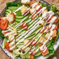 Avocado Caesar Salad · Spring mix salad with crunchy garlic croutons, avocado, tomatoes, and homemade caesar dressing