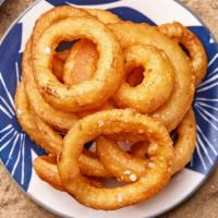 Onion Rings · Juicy white onions battered and fried to a crispy perfection served with our Crack Sauce.