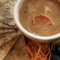 Roti Dip Curry · Medium spicy. Chicken or vegetable.  Roti bread with a side of curry sauce.