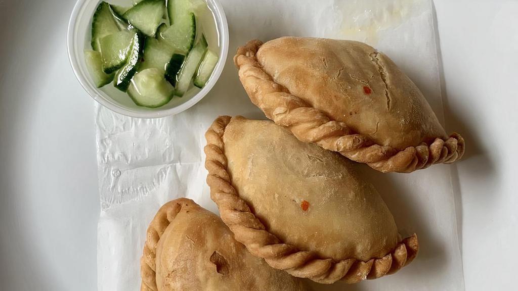 Chicken Curry Puffs (3) · Minced chicken, sweet potatoes and curry power stuffed in homemade pastry served with cucumber salad