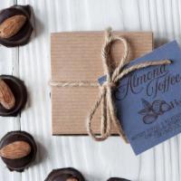 Tiny Toffee Caramel · Eight pieces of buttery toffee and roasted almonds, encased in semi-sweet (55% cacao) chocol...