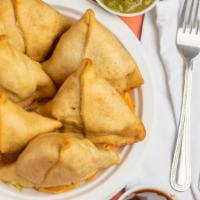 Samosa · Puff pastry stuffed with potatoes, peas, and spices