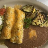 Enchiladas Rancheras · Sautéed chicken with onions, tomatoes, cilantro rolled in three corn tortillas topped with s...