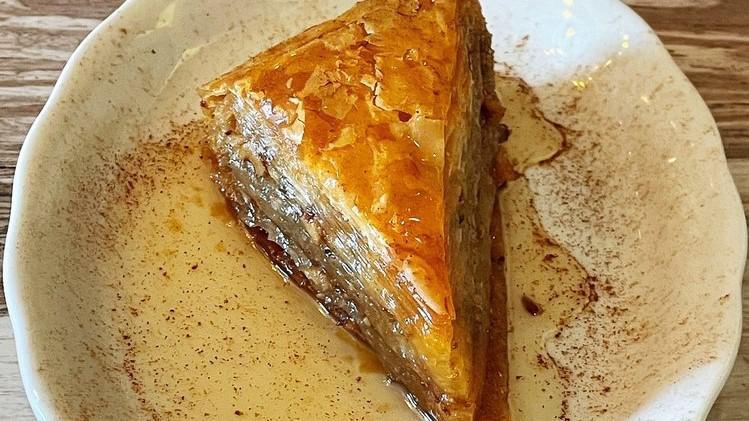 Baklava · Phyllo dough layered with chopped walnuts, cinnamon, and honey syrup.