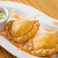 Curry Puff (2) · Crunchy little parcels of fried pastry filled with chicken and potato served with cucumber r...