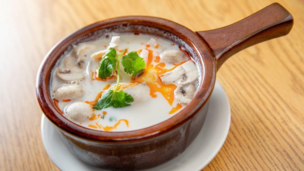 Tom-Kha Soup · Traditional coconut soup with lemon grass, galangal, onion, mushroom, lime juice, and cilantro topped with thai chill oil.