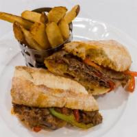 Philly Steak Sandwich · Shaved Roast Beef, Sautéed Peppers & Onions, Served with Spicy Steak Sauce on Garlic Bread.