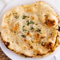 Garlic Naan · Breads cooked with garlic and herbs.