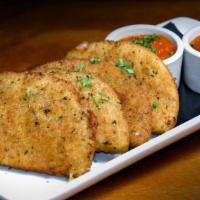 Mozzarella Moons · parmesan-panko crust, lightly fried and served with marinara dipping sauce