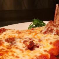 Veal Chop Parmigiana · Bone in veal chop pounded thin, pan fried topped with mozzarella & red sauce