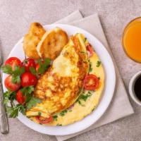 Mardi Grass Omelette Platter · Fresh served scrambled eggs omelette with ham, bacon, tomatoes and cheddar cheese. Served wi...