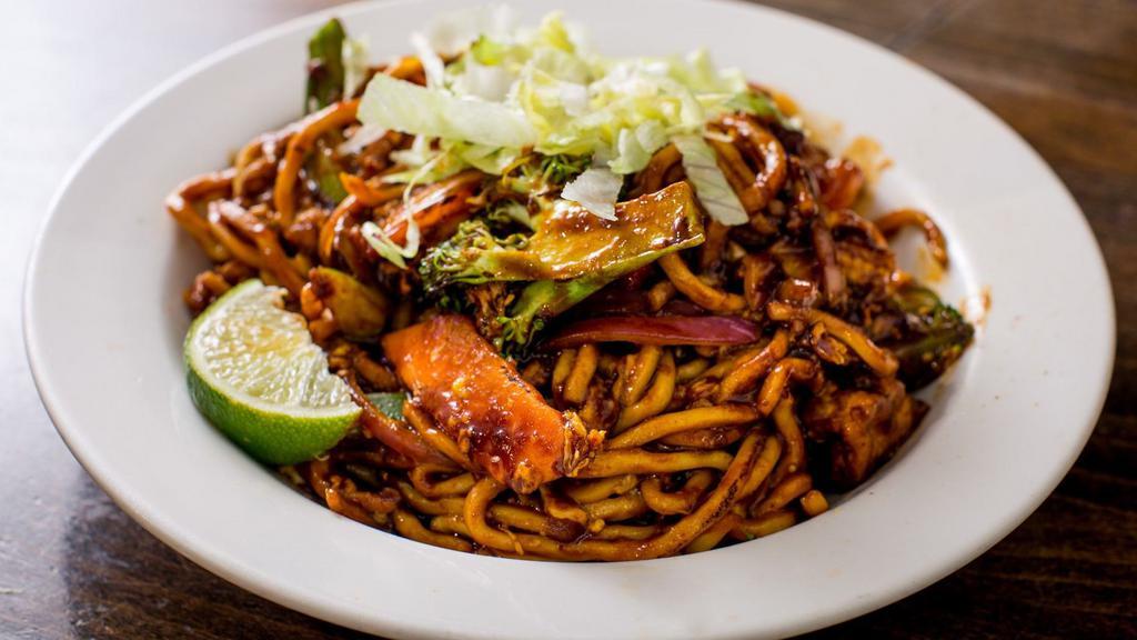Mee Goreng · Hot & spicy. Mamak style stir fried egg noodle, fried tofu, egg, bean sprout, shredded lettuce, peanuts, fresh lime.