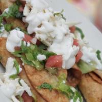 Chicken Flauta · Three crispy tacos topped with lettuce, pico de gallo, cheese and sour cream.