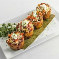 Piononitos · Puerto Rican timbales of sweet plantains, ground beef, and cheese topped with pico de gallo ...