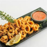 Classic Crackling Calamari · Lightly breaded calamari served with a warm spiced marinara sauce.