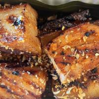Liempo Solo · grilled pork belly appetizer, lime wedges, crispy garlic