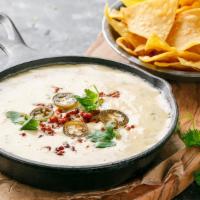 Hot Queso Blanco & Chips · warm white cheddar cheese dip with pico de gallo toppings and side of nacho chips