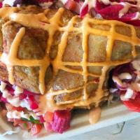 Pollo Chuco Hondureño · fried half chicken, tostones, salsa rosada, pico de gallo, pickled red onions, cabbage salad