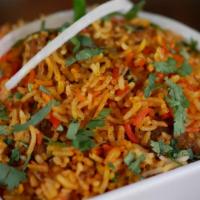 Chicken Biryani · Slowly cooked rice with chicken and spices. Served with raita on side