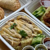 Hainan Chicken / Kheo Mon Gai · Over ginger rice with dear chicken broth.