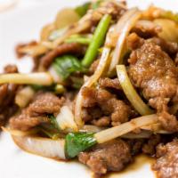 Mongolian Beef · Spicy. Slices of tender beef sauteed with onions and scallions in Mongolian sauce with a hin...