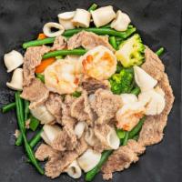 Four Precious Jewels · Jumbo shrimp, scallops, squid, and sliced beef with snow peas, broccoli, carrots, and baby c...