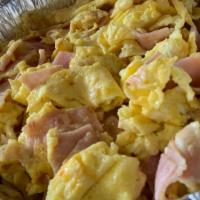 Huevos Con Jamon · Eggs with ham mixed together. It is served with rice, beans, and tortillas on the side.