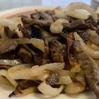 Bistec Encebollado · Grilled steak mixed with grilled onions. It is served with rice, beans, and tortillas.