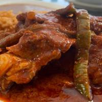 Adobo Rojo De Puerco · Pork ribs with nopales (sliced cactus) in red adobo sauce. Served with rice, beans, and tort...