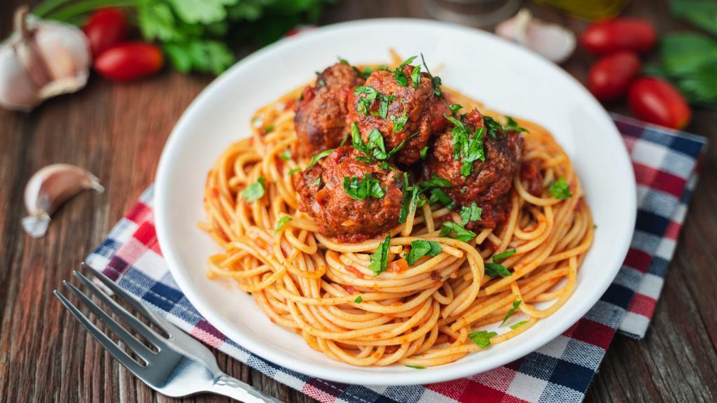The Spaghetti & Meatballs · Fresh made marinara, savory beef meatballs, parmesan cheese, and basil sitting on a bed of fresh made spaghetti.