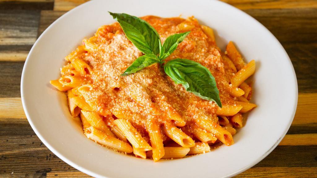Penne Alla Vodka · Parmesan cheese, basil, and fresh vodka sauce sitting on a bed of penne.