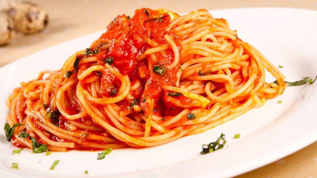 The Spaghetti · Fresh made marinara, parmesan cheese, and basil sitting on a bed of fresh made spaghetti.