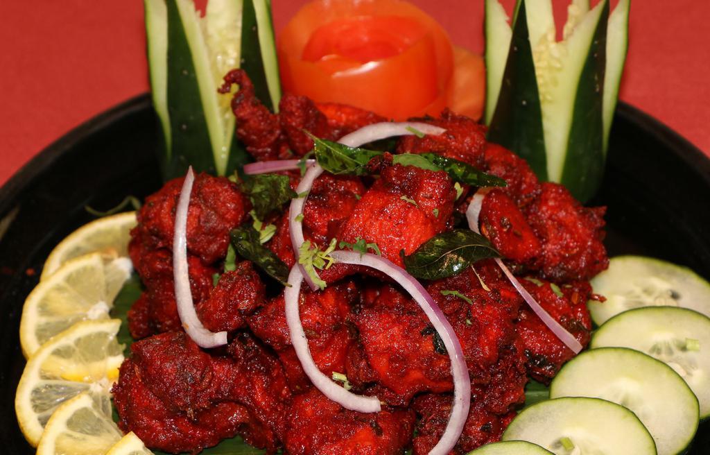 Kozhi 65 · Cubes of chicken marinated in yogurt and spices, deep fried.