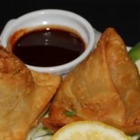 Street Samosa · Vegan. Tri-folded puff pastry with potatoes, chilies, mint, cilantro and chat masala.