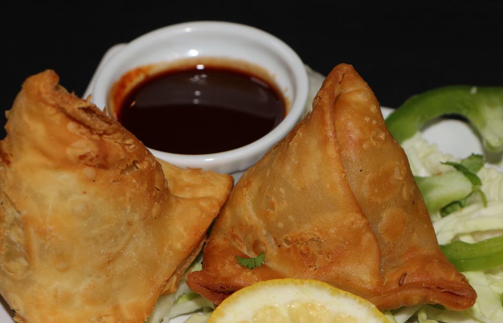 Street Samosa · Vegan. Tri-folded puff pastry with potatoes, chilies, mint, cilantro and chat masala.